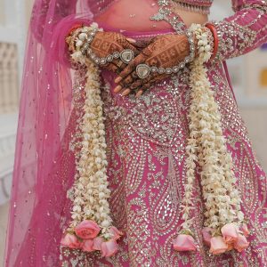 free-photo-of-elegant-bride-in-ornate-pink-lehenga-with-floral-garlands