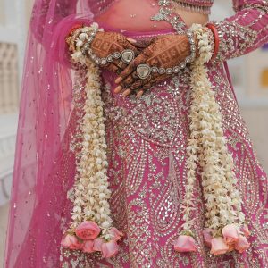 free-photo-of-elegant-bride-in-ornate-pink-lehenga-with-floral-garlands